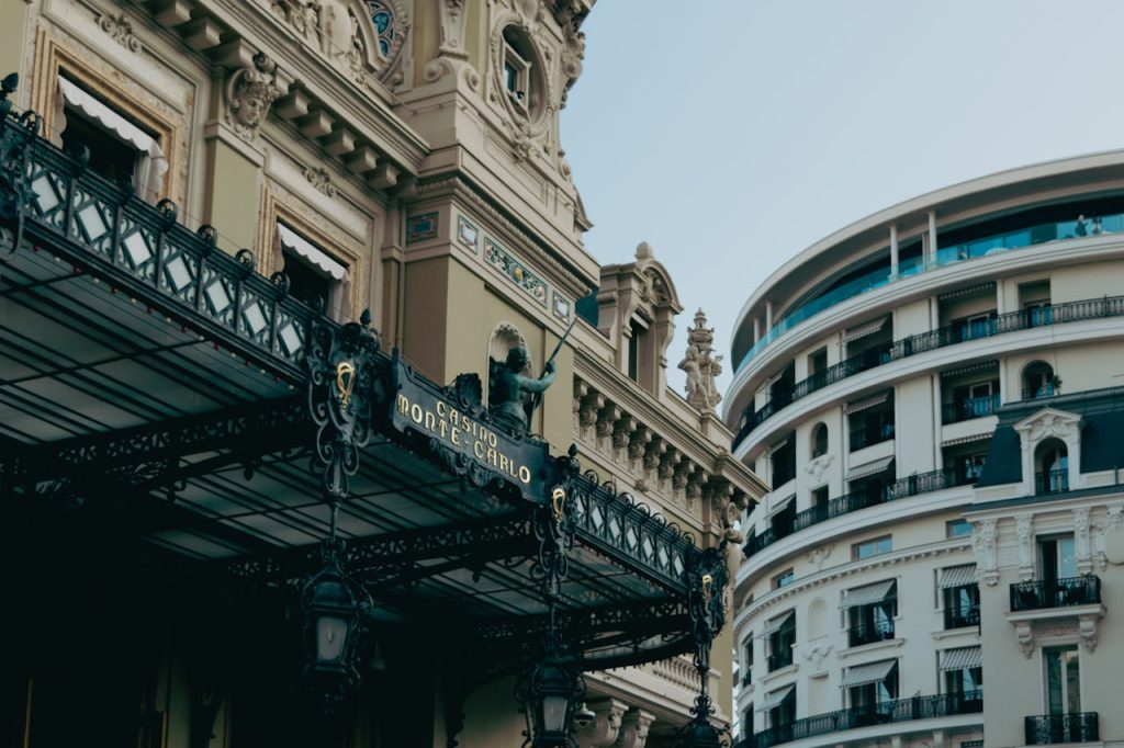 Elegant architecture of Monte Carlo Casino and nearby building in sunny Monaco.